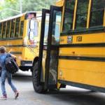 Students getting off a yellow school bus